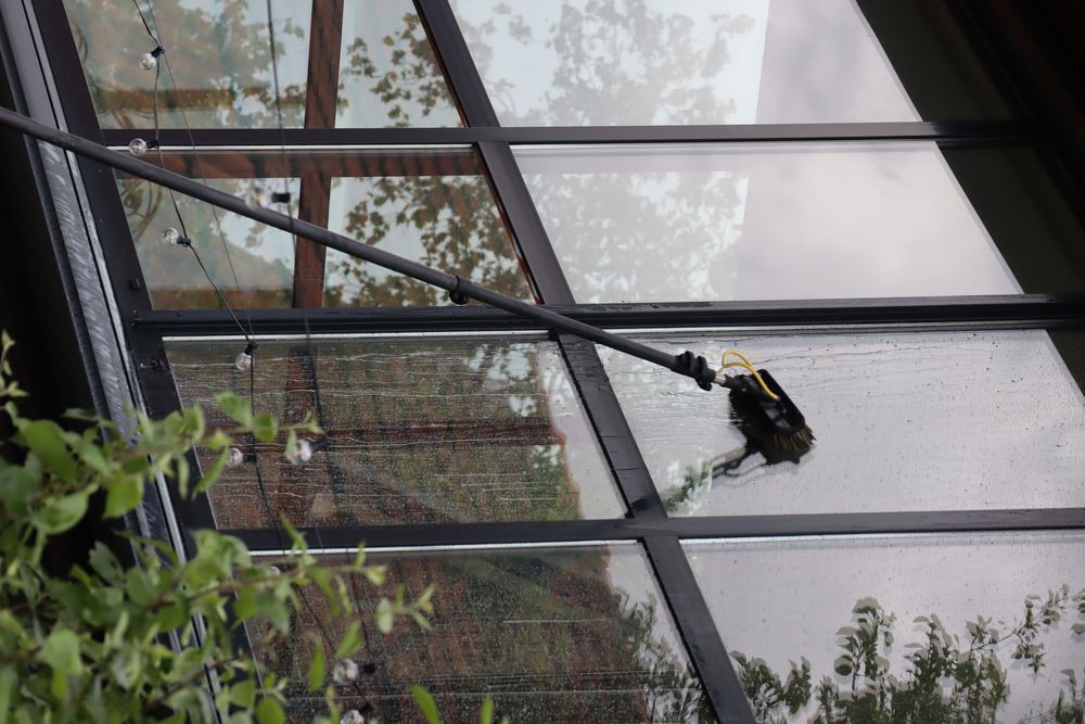 Detail van het reinigen van een glazen serredak